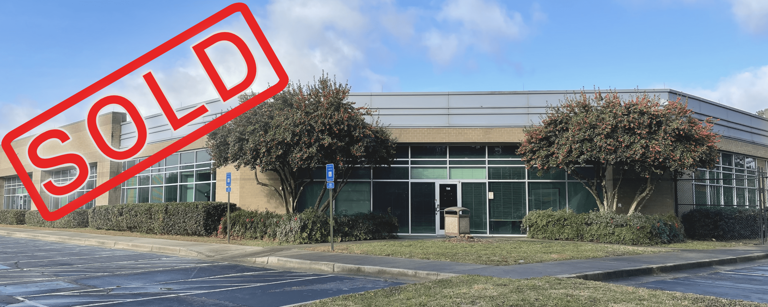 A building with a red sign in front of it