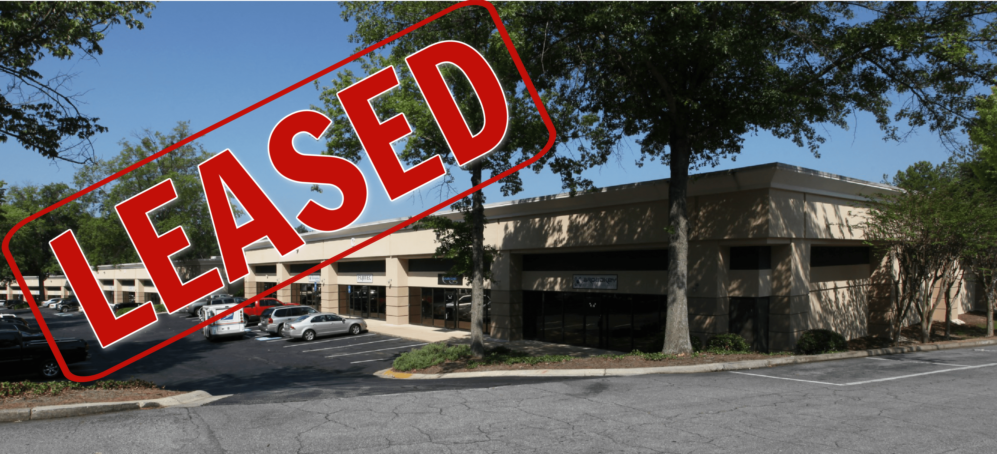 A large building with a red sign that says " used ".